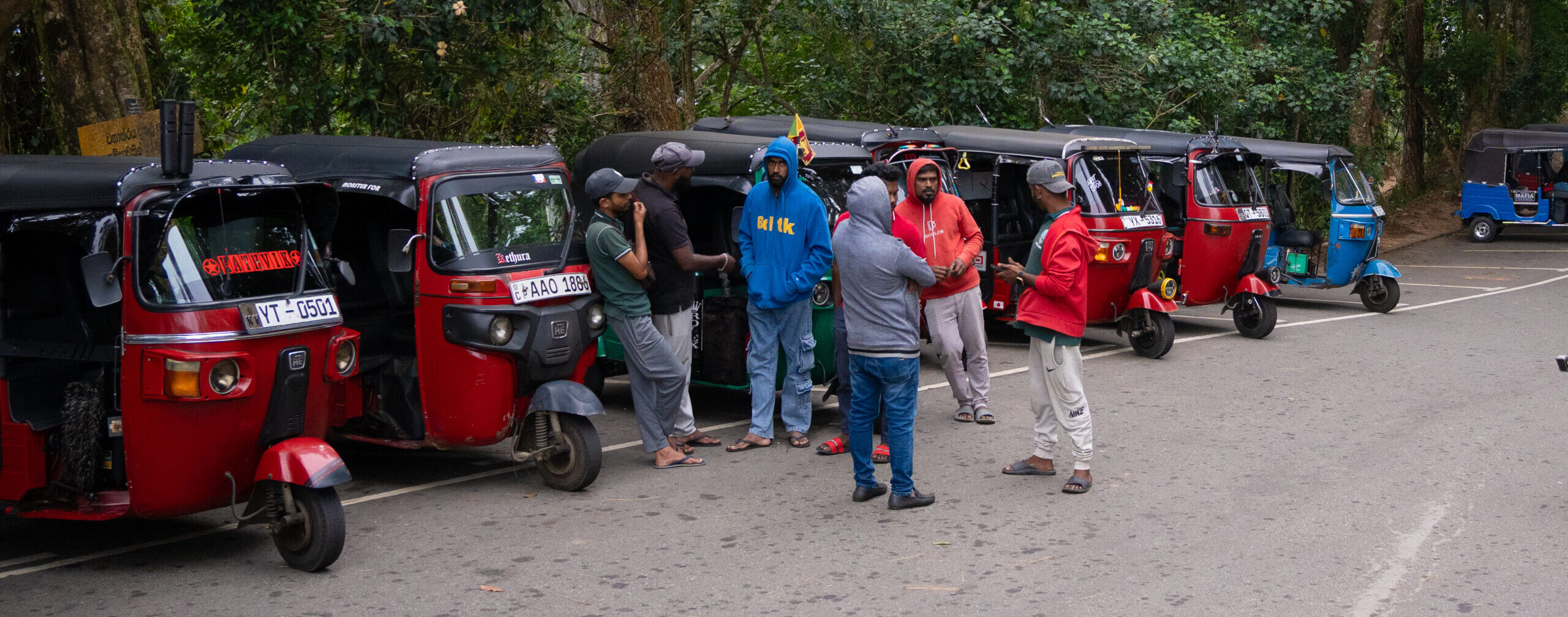 A row of tug-tuks waiting for tourists outside of Ambuluwawa Tower near Kandy