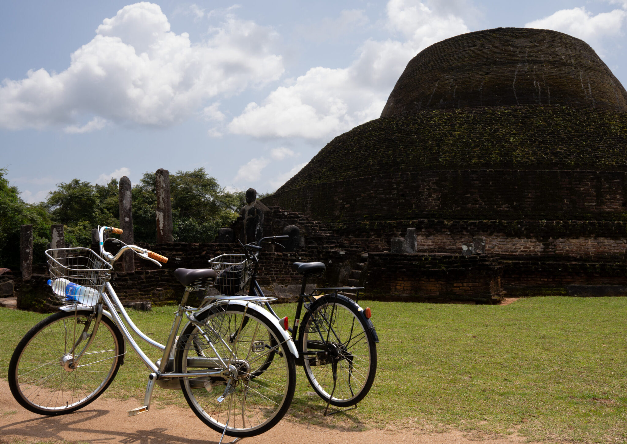 Rented bicycles parked up next to a stop inside Polonnaruwa