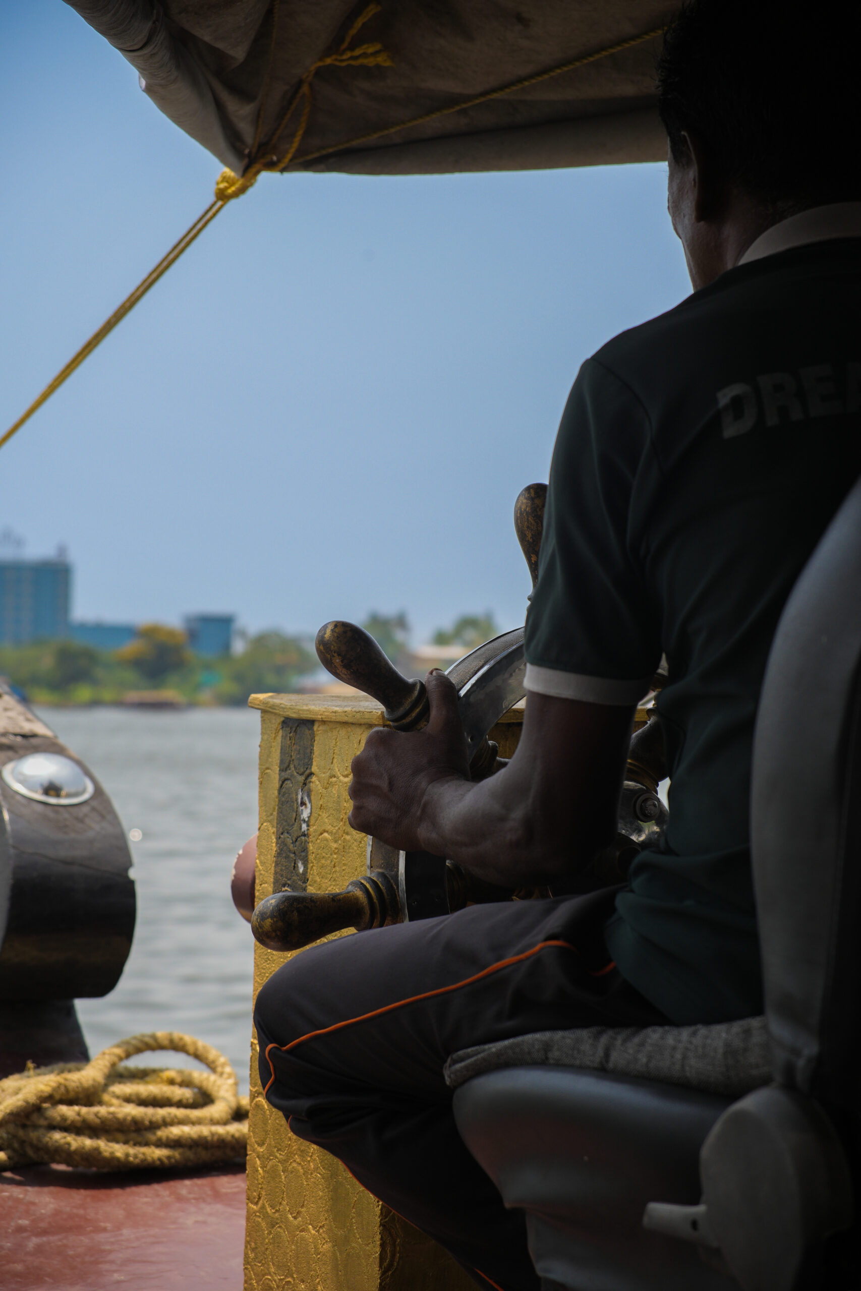 The houseboat captain sailing through the backwaters of Kerala