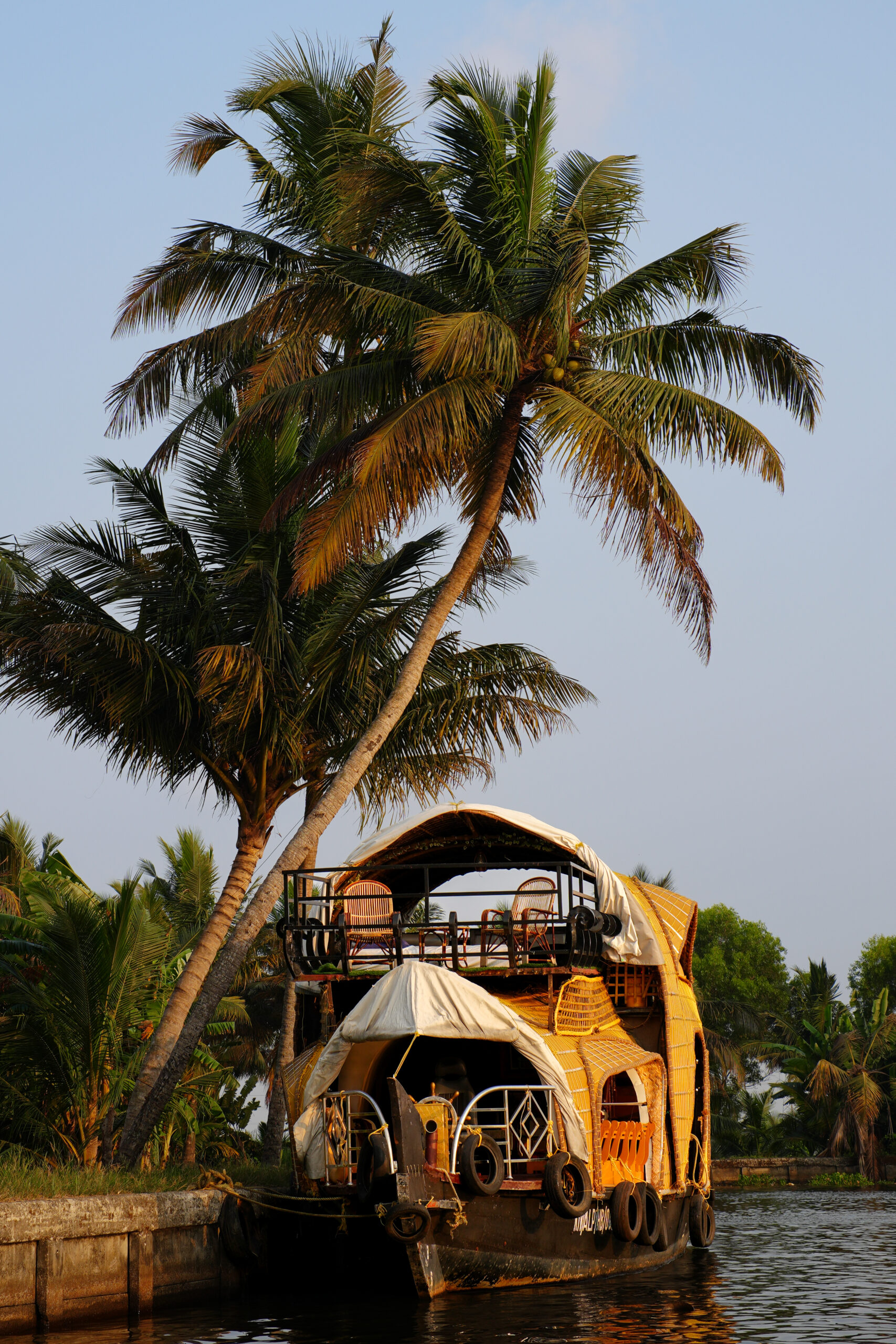 A traditional houseboat in the golden sunlight on the backwaters of Alleppey