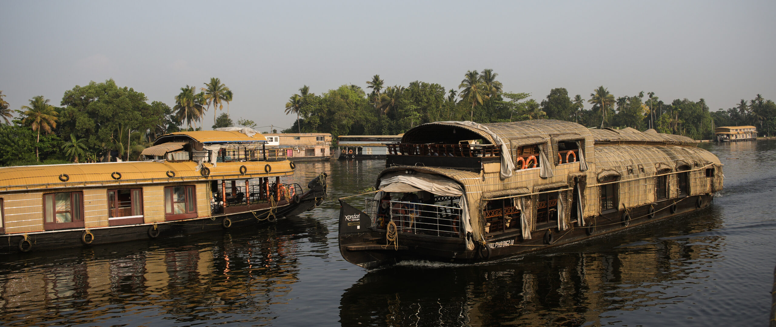 The crowded waterways with other houseboats in Alleppey, Kerala