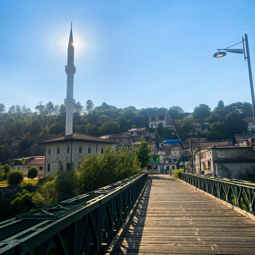 The bridge to the lakeside villages of Shkodra Lake with a minaret under the sun. A free activity in Albania to keep the trip budget-friendly.