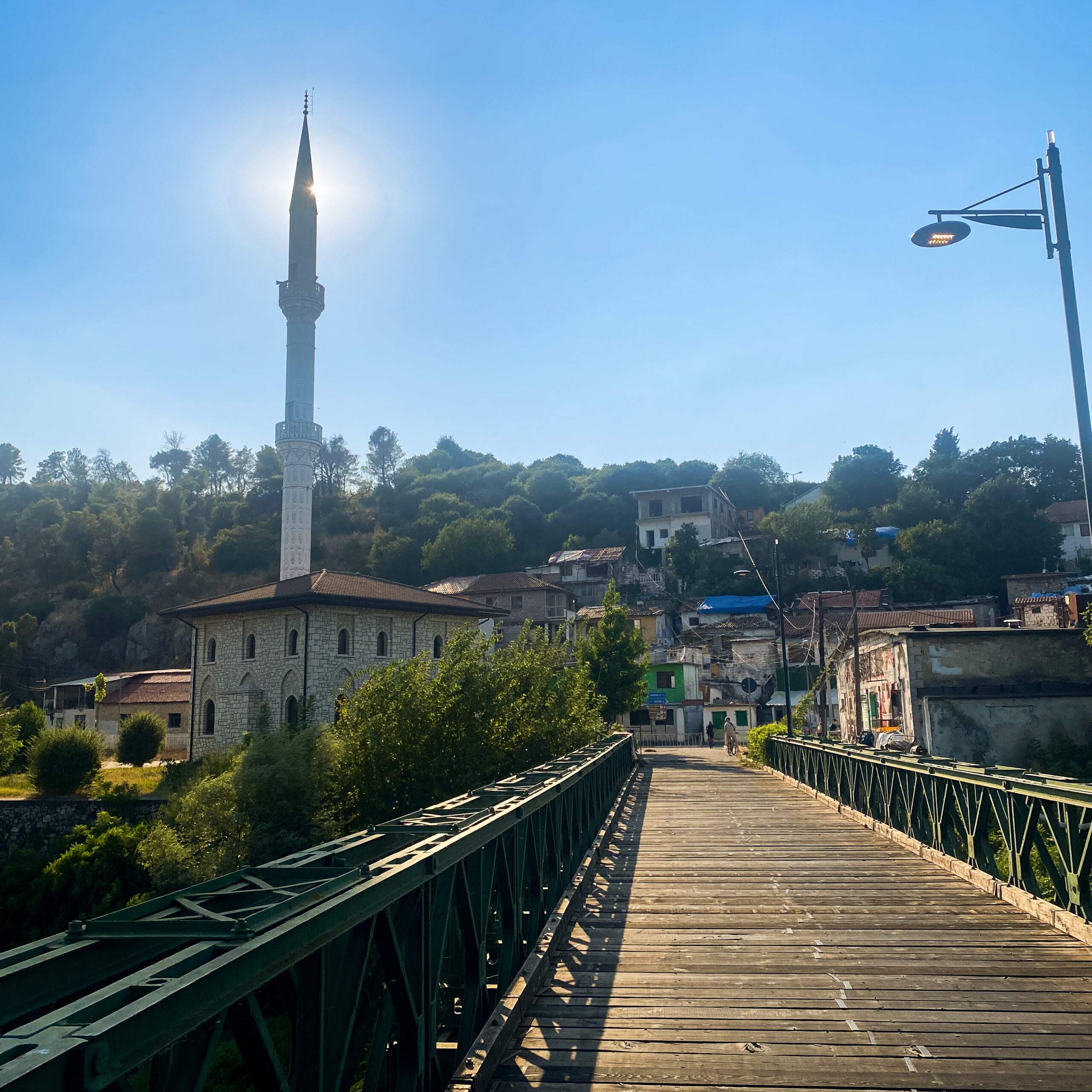 The bridge to the lakeside villages of Shkodra Lake with a minaret under the sun. A free activity in Albania to keep the trip budget-friendly.
