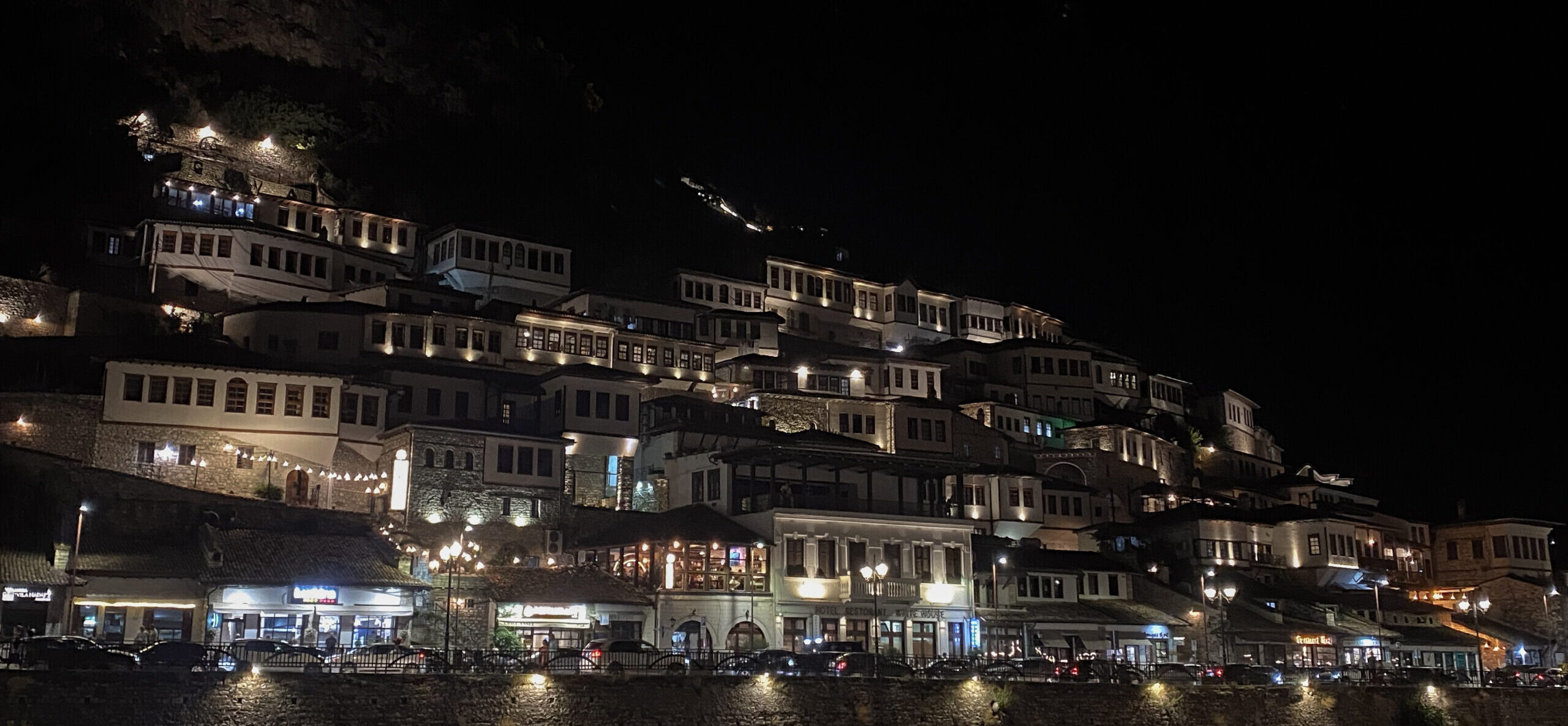 The stunning houses that sit on the hillside in the gorgeous, historical town of Berat at night.