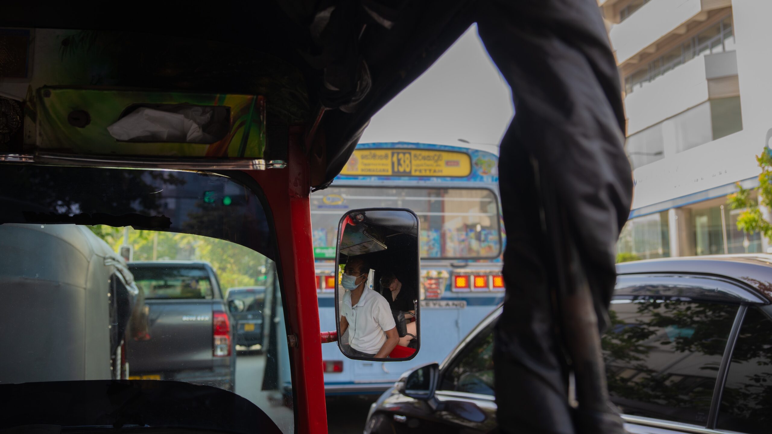 A tuk-tuk stuck in city traffic in Colombo, Sri Lanka