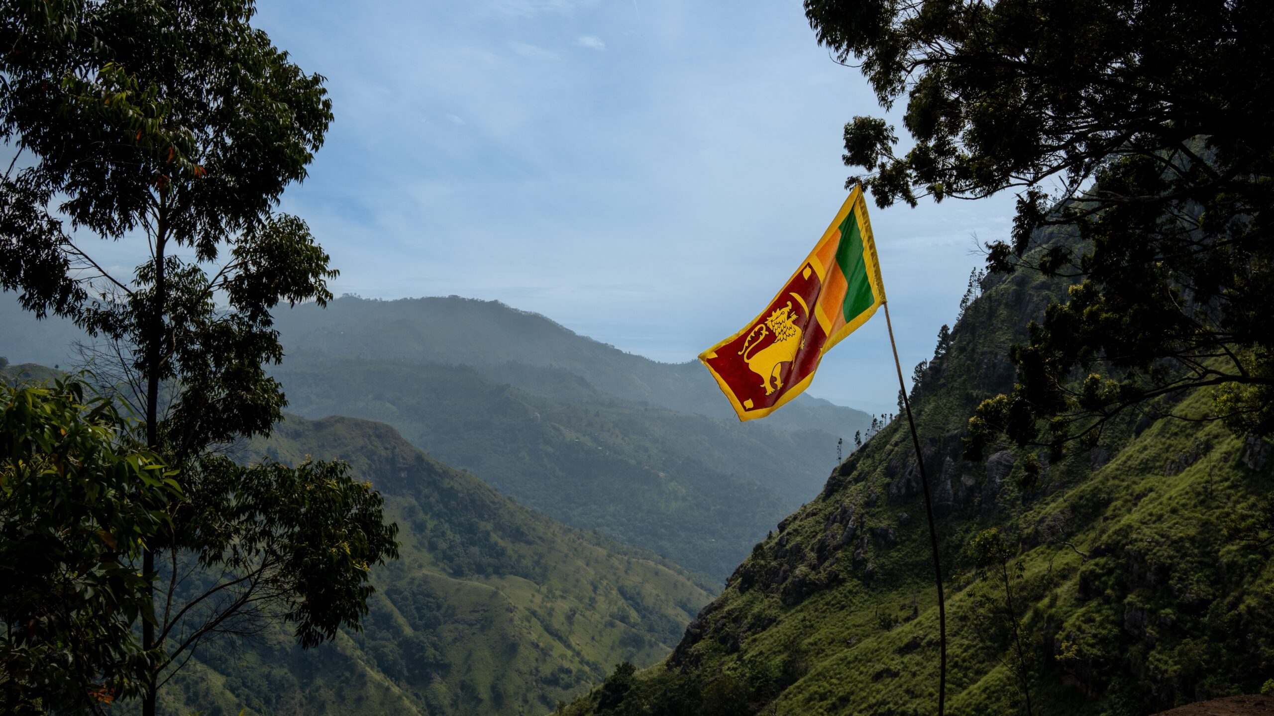 A view of the highlands in Sri Lanka with the flag waving in contrast to the beautiful landscape