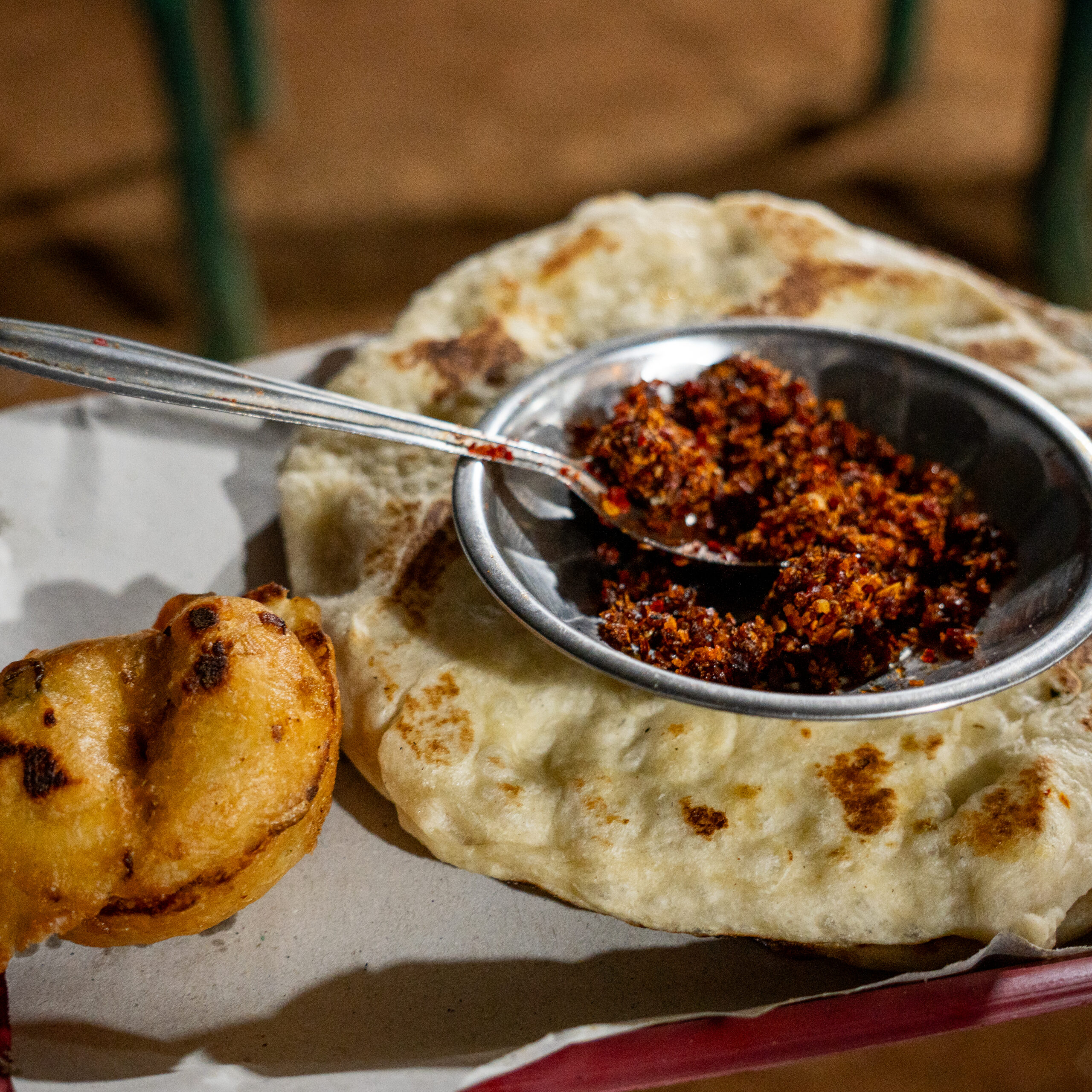 A roti and medu vada served with a chilli condiment