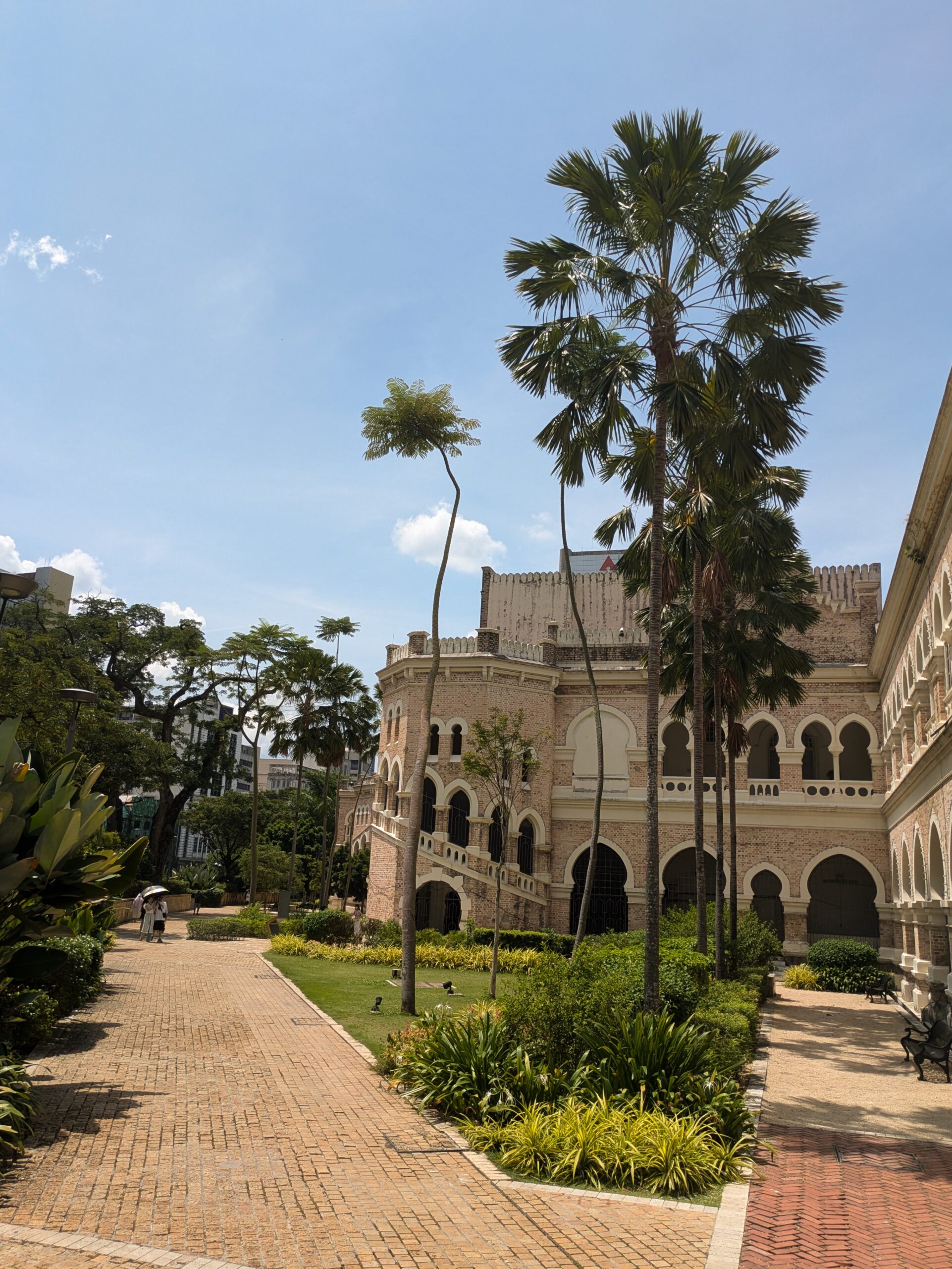 British colonial architecture with gorgeous gardens and a bright blue sky
