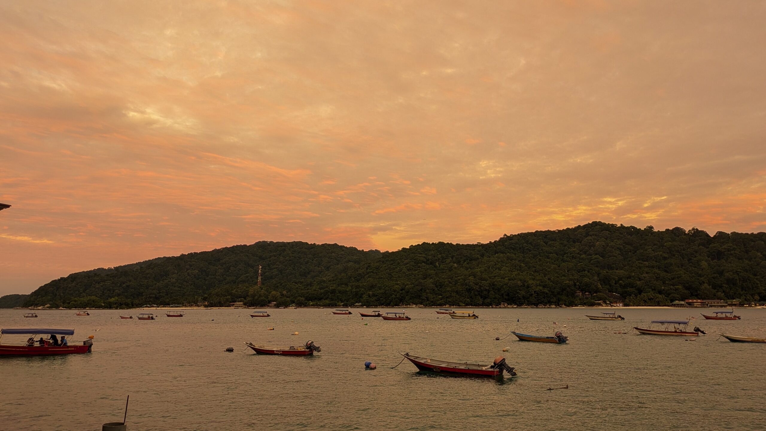 An extreme orange sky at sunset over the water on the Perhentian Islands, Malaysia