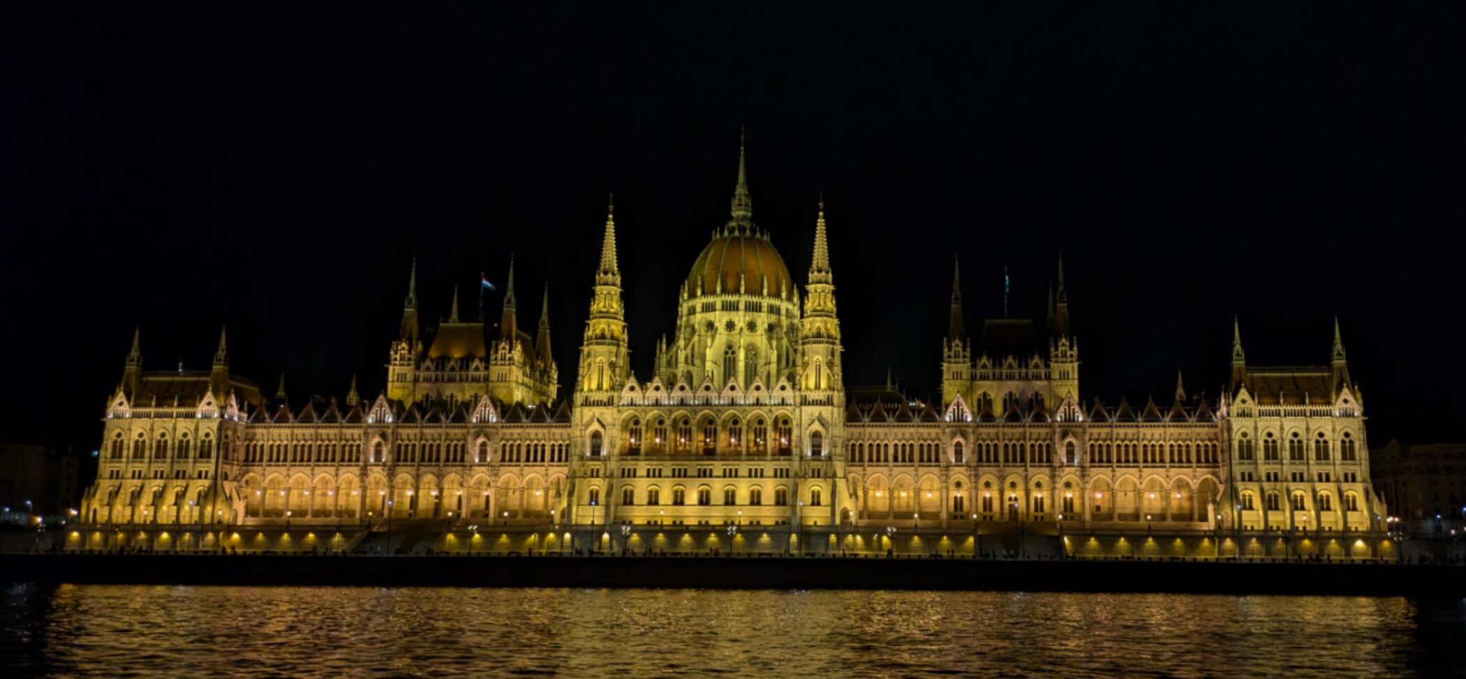 A view of the illuminated Hungarian Parliament Building during a Danube River Cruise at night