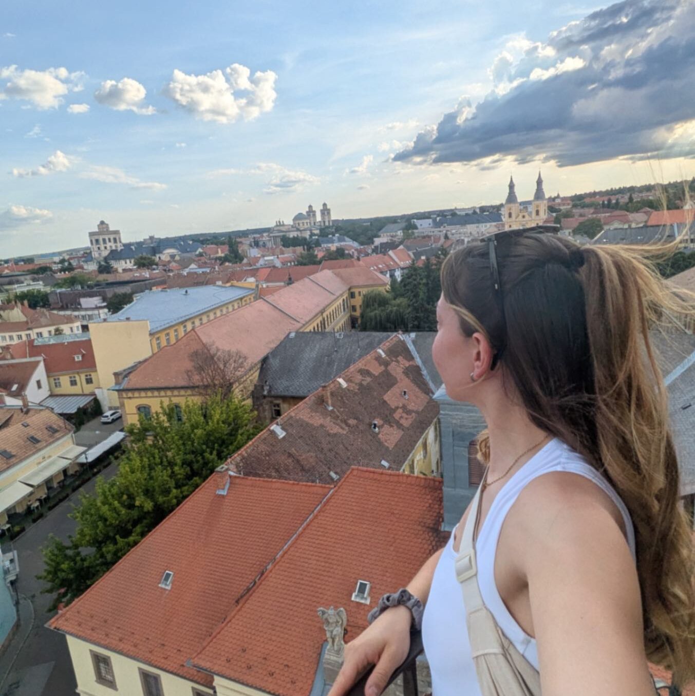 Stood high up on something that gives a view of a Hungarian city, Eger.