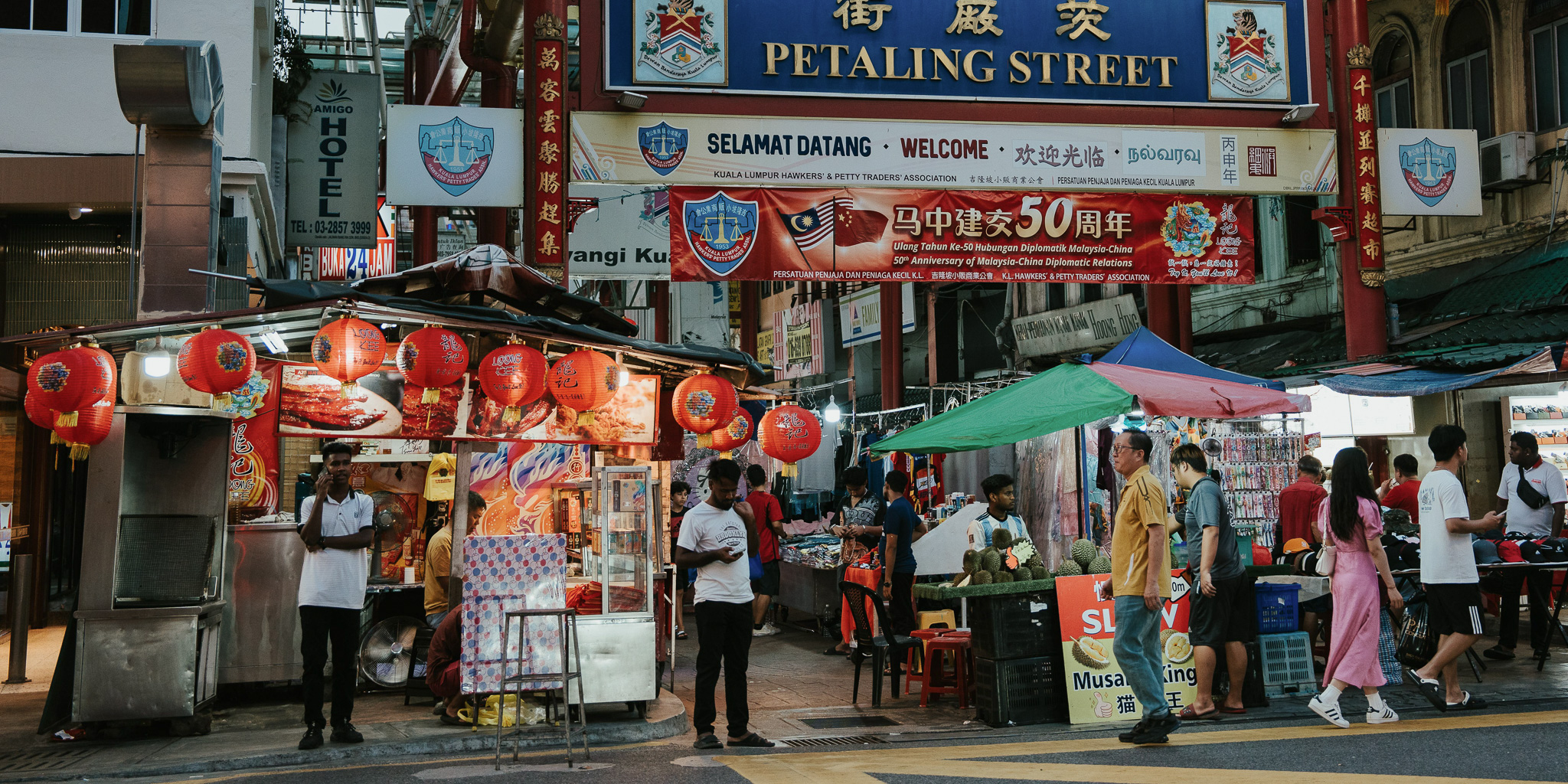 The bustling street of Petaling Market selling clothes, food and so much more as the sun comes down and the night lights come on