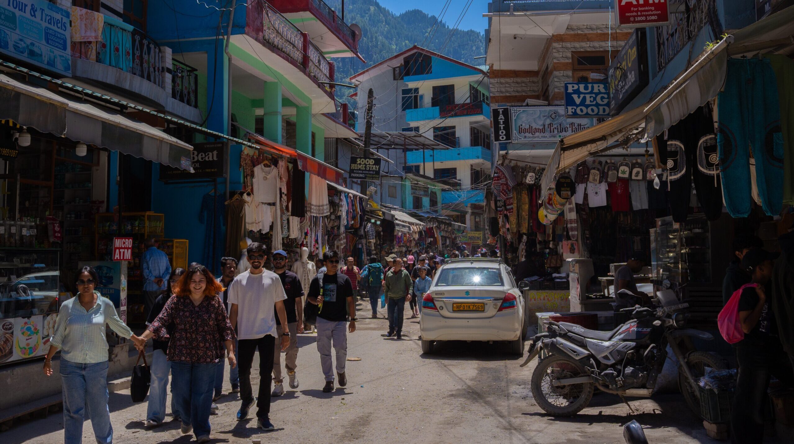 The busy town of Kasol, with west symbol tops hanging up.
