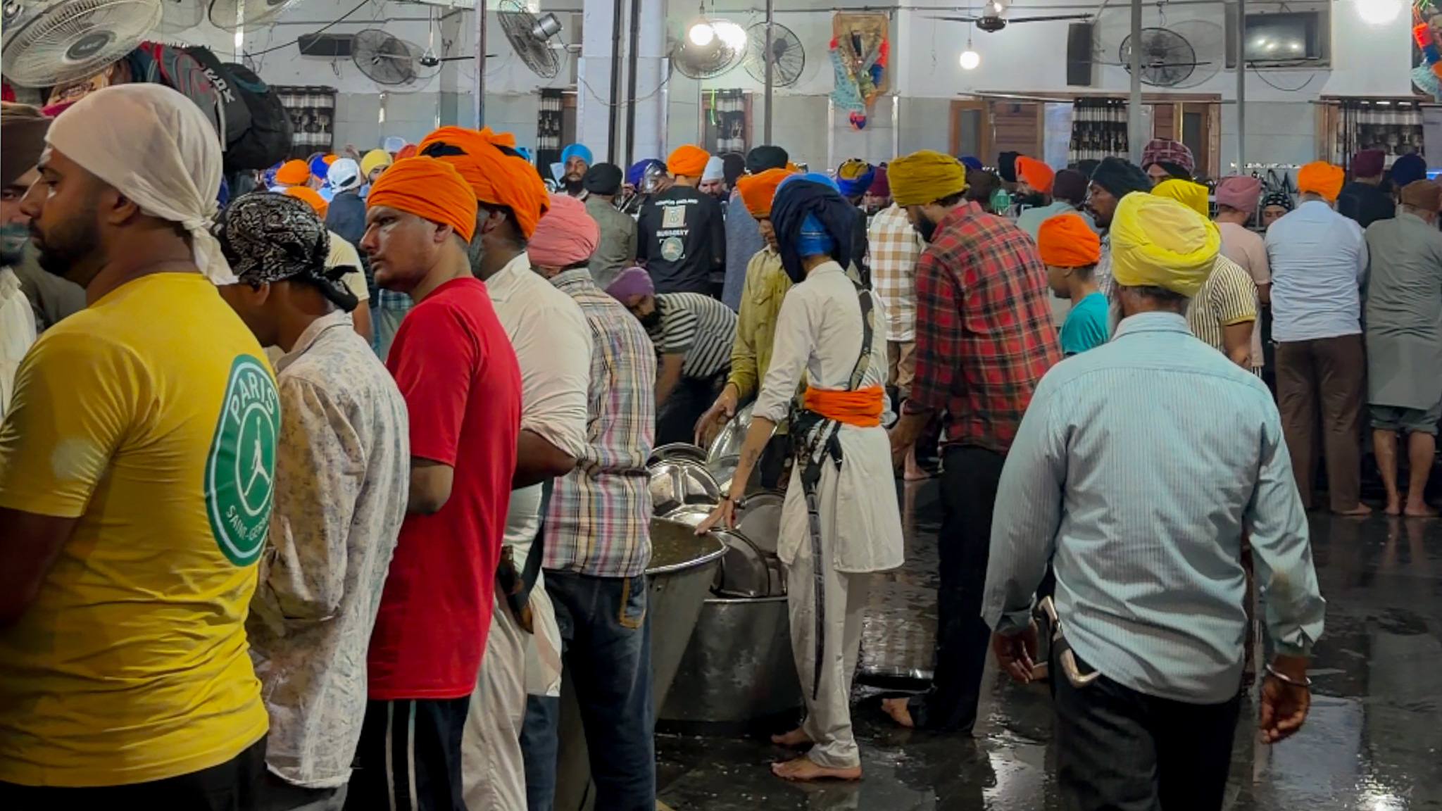 The volunteers in the community kitchen of Golden Temple cleaning the dishes