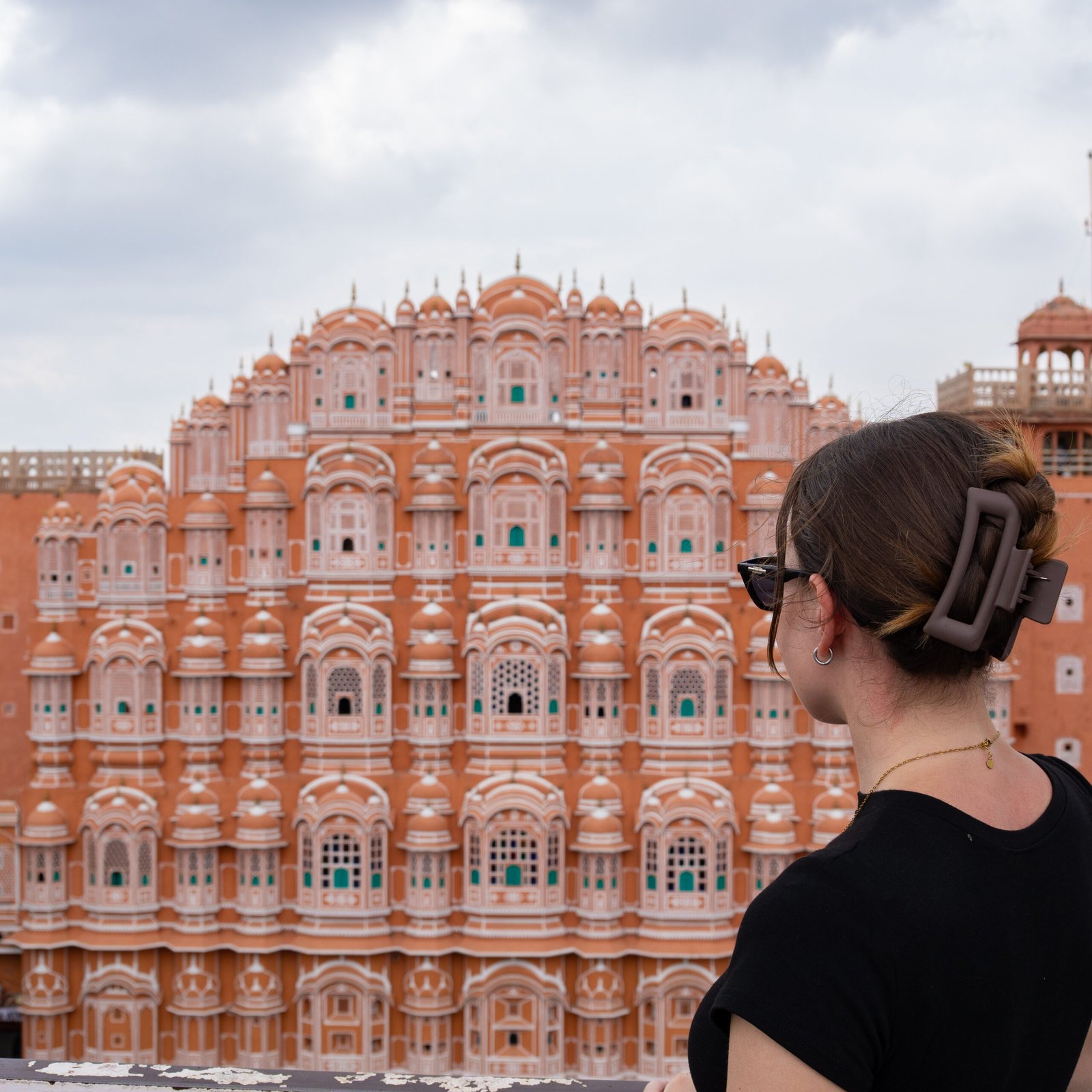 A women stood looking out at Jawa Mahal - one of the most popular things to do in Jaipur