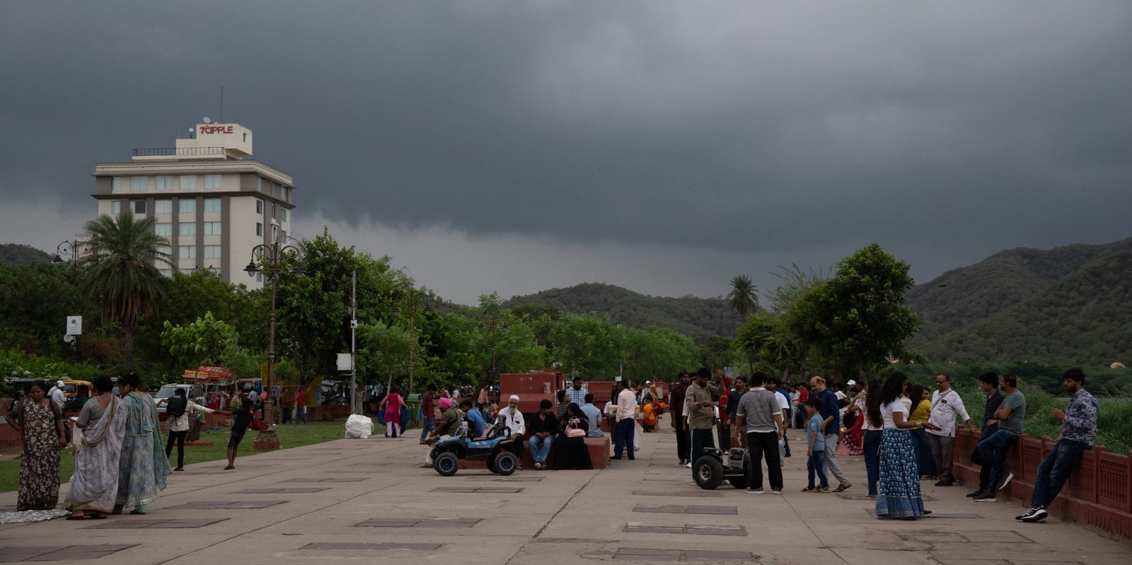 A promenade with lots of people around and a very grey sky