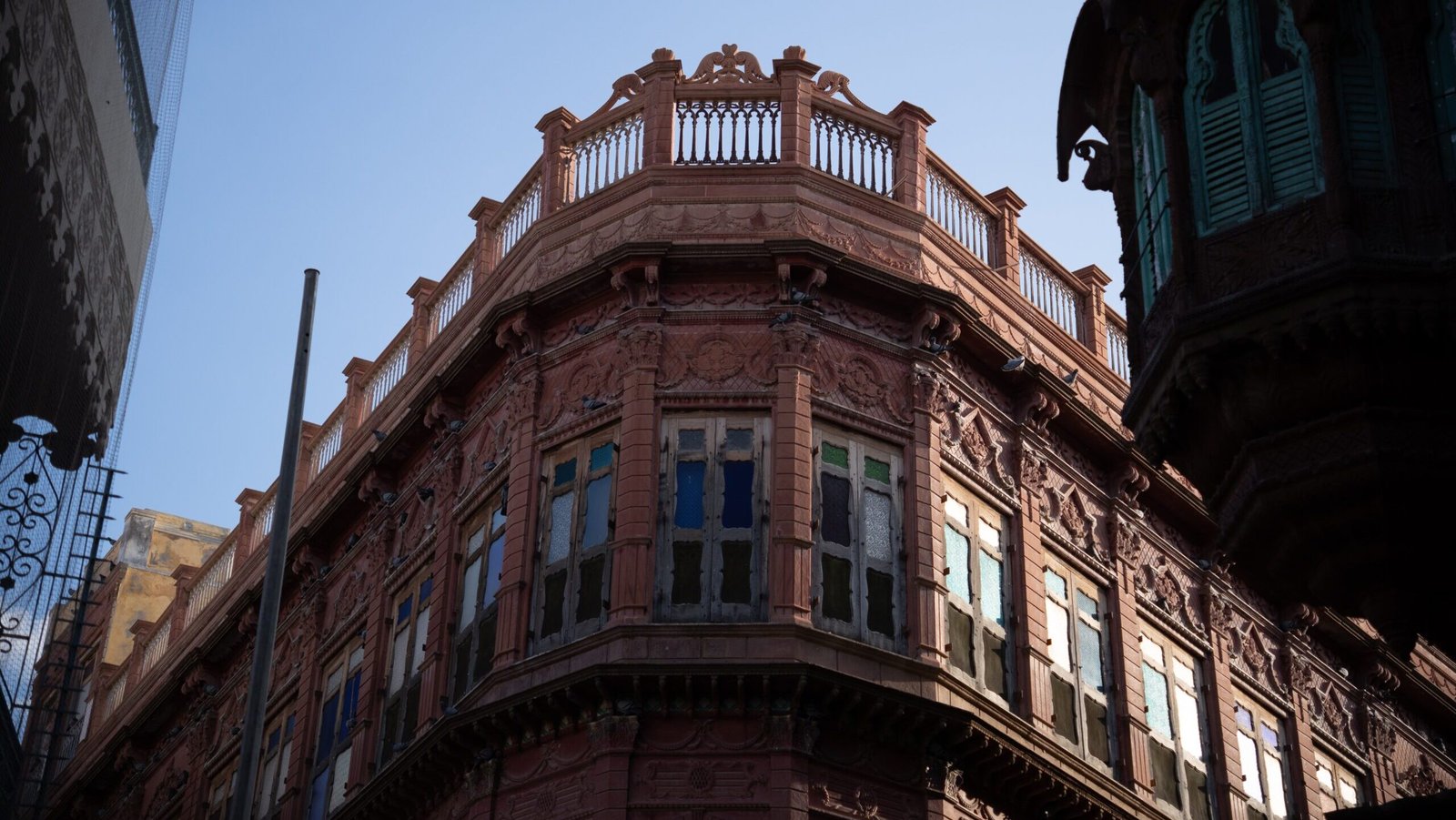 The top of a haveli in Bikaner featuring red architecture and windows