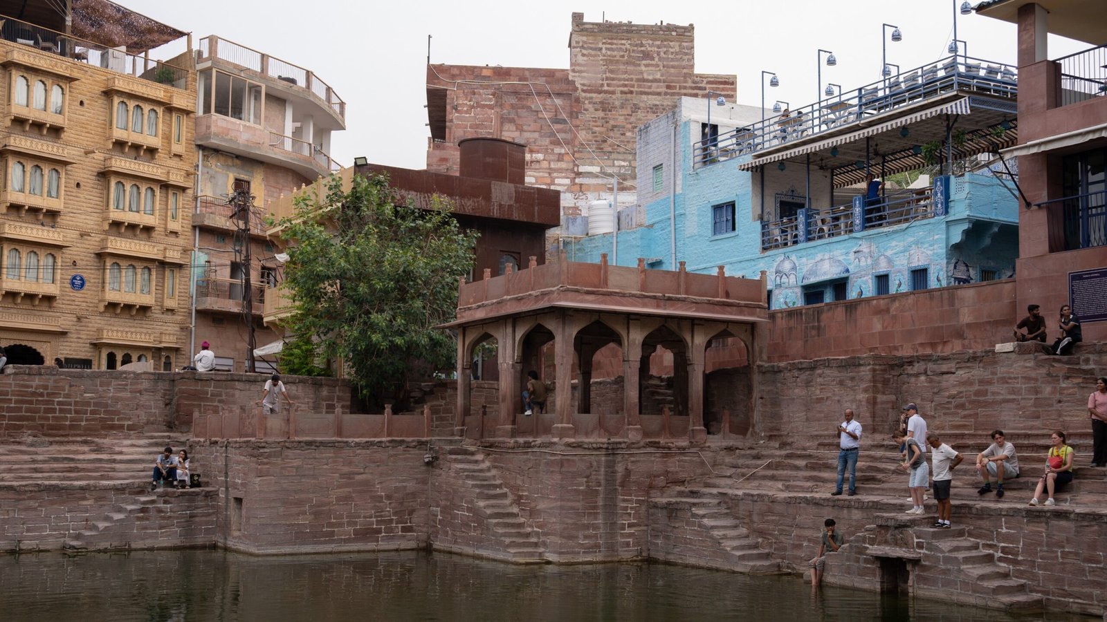 A stepwell in Jodhpur, with young boys jumping in the waters below