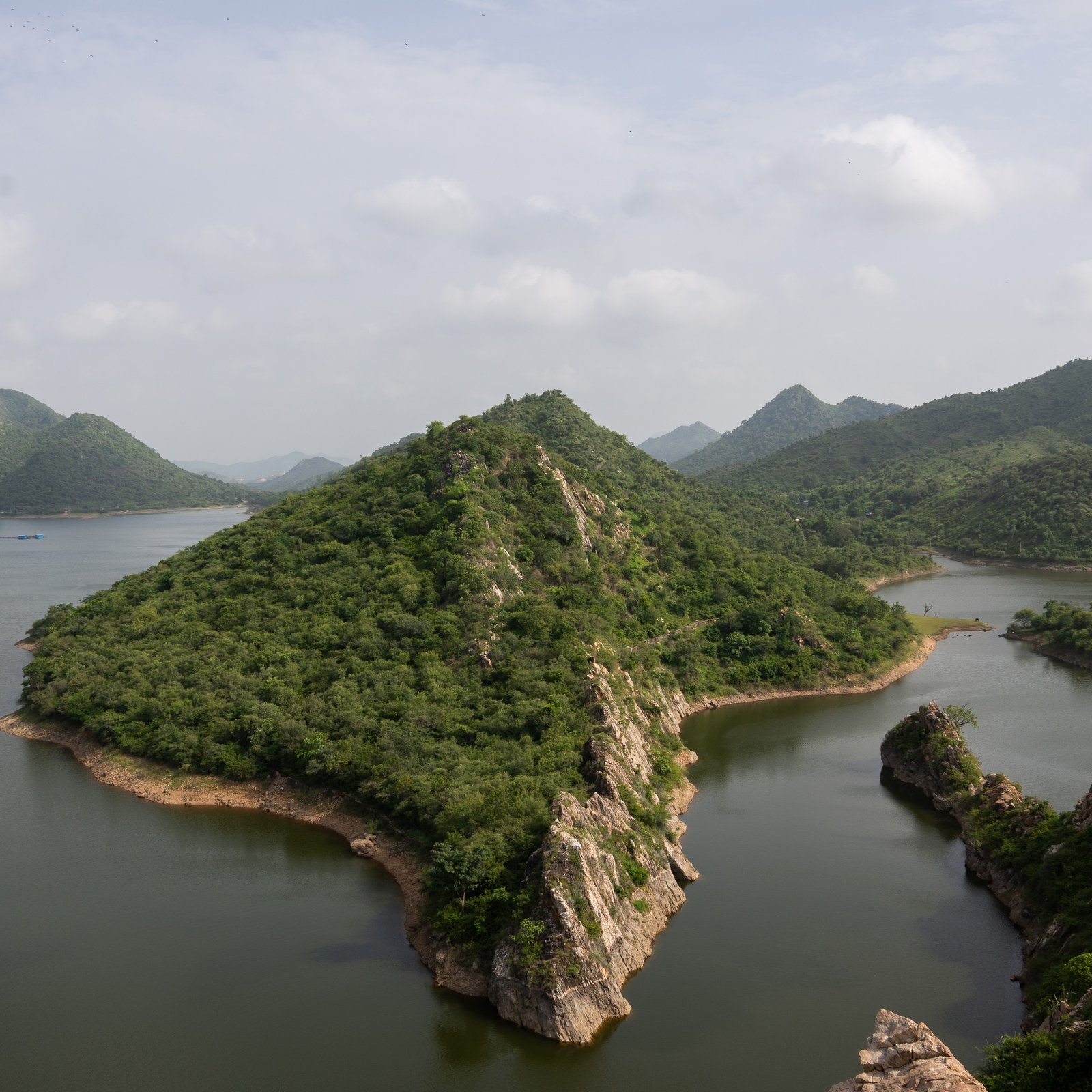 Bahubali Hills in Udaipur, India - surrounded by a lake and lush greenery on the hills