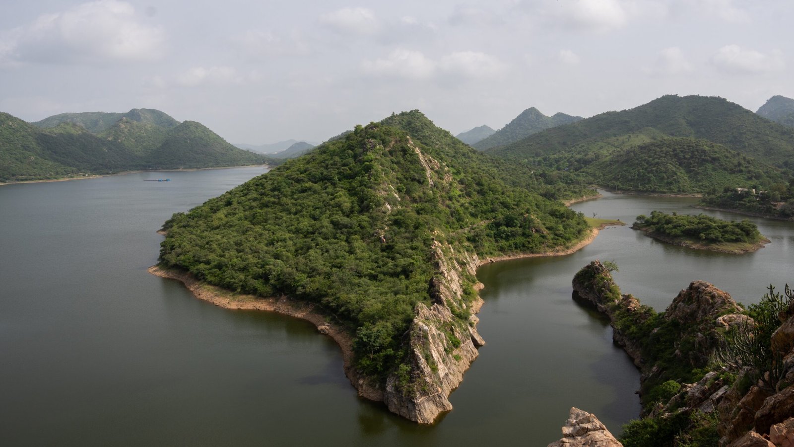 Bahubali Hills in Udaipur, India - surrounded by a lake and lush greenery on the hills