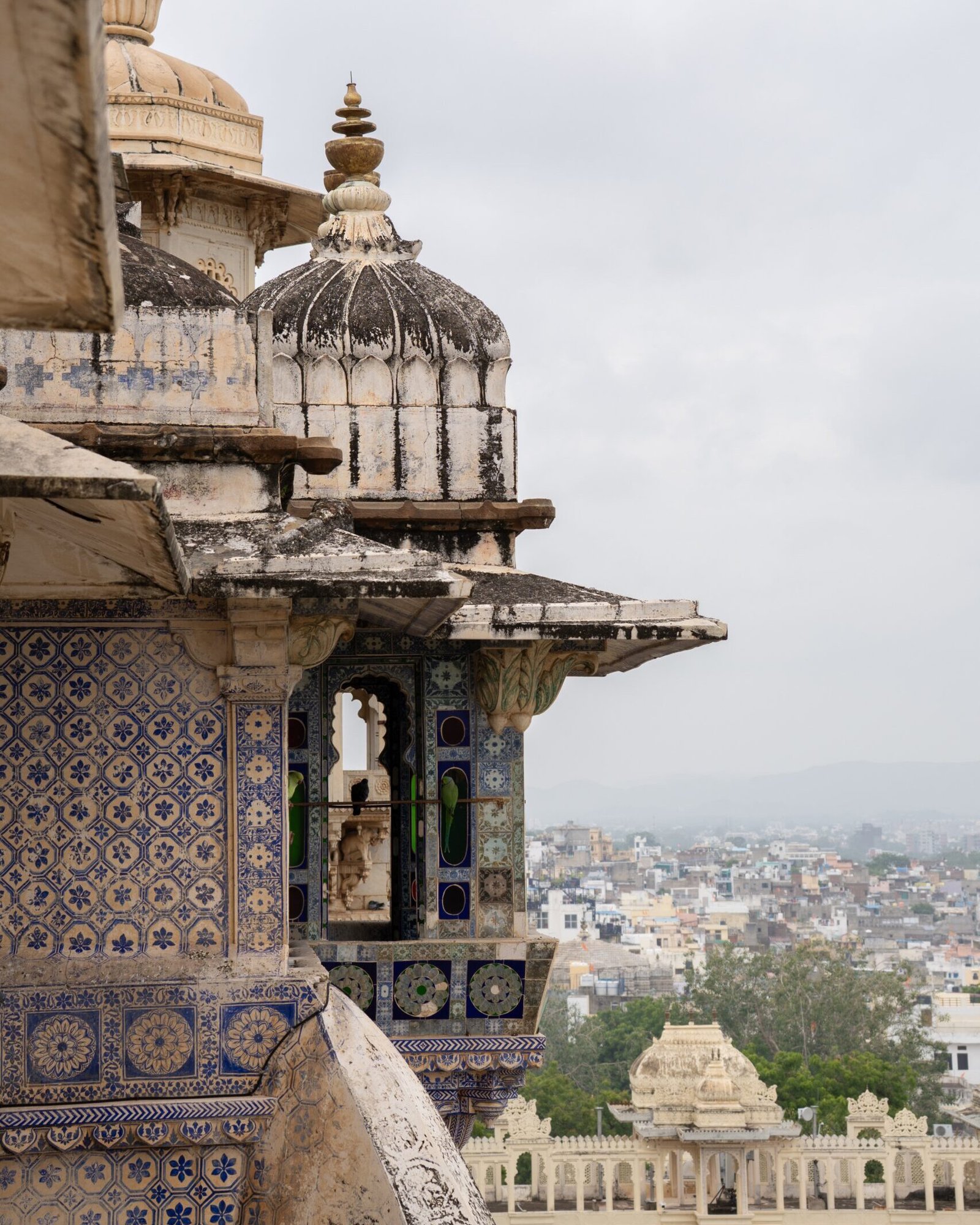 The outside of the City Palace in Udaipur with views of the city below