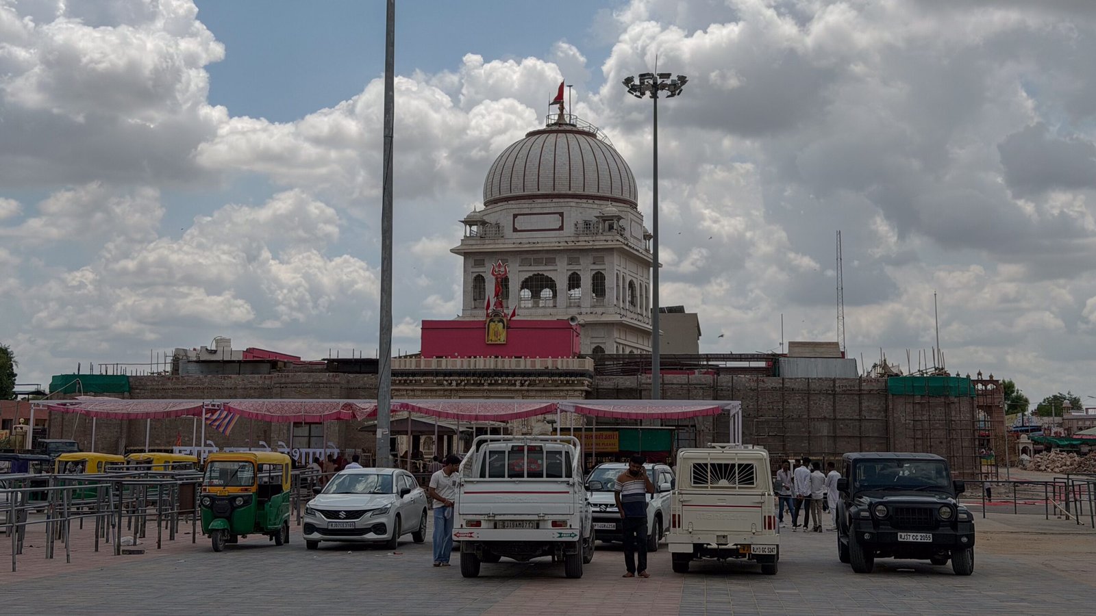 The outside of the Karni Mata Temple with cars parked up