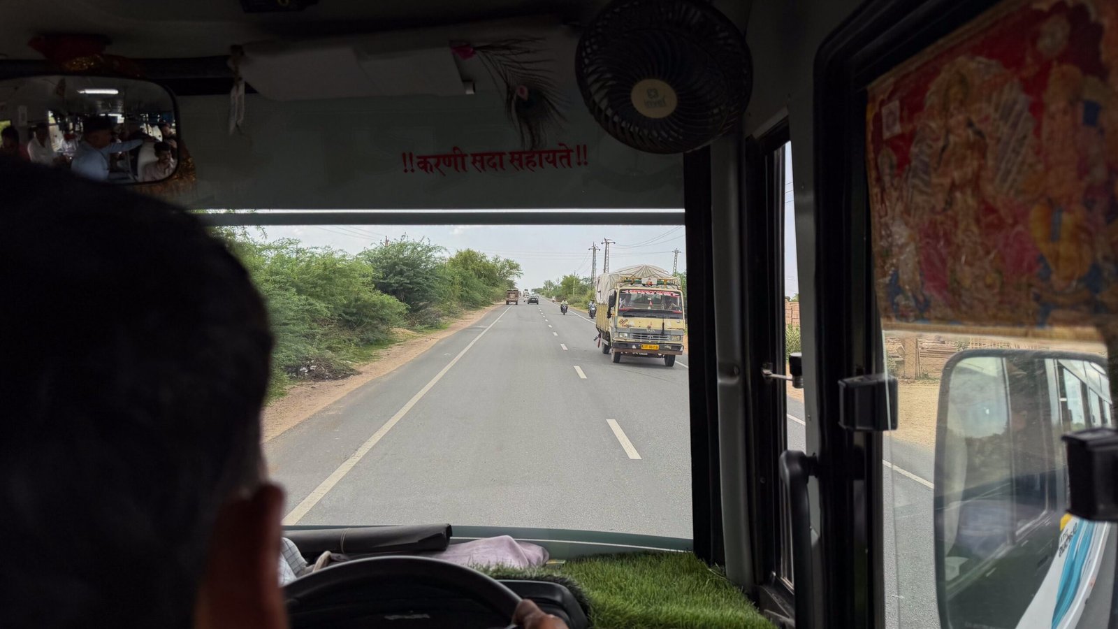A view out the front of a bus driving on a main road