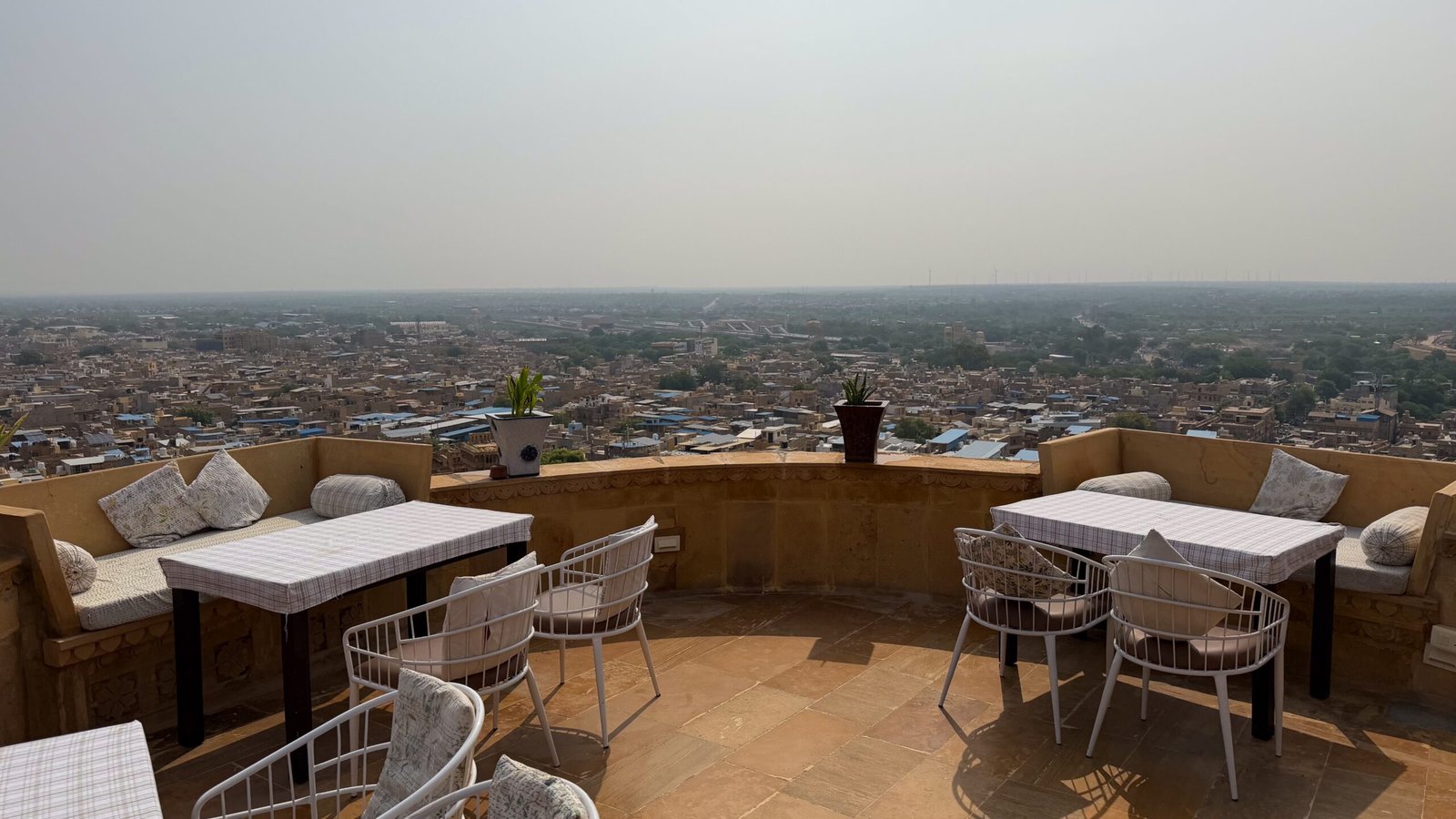 A rooftop restaurant offering vies of a desert city below. A haveli restaurant from inside Jaisalmer Fort overlooking Jaisalmer city and the Thar Desert