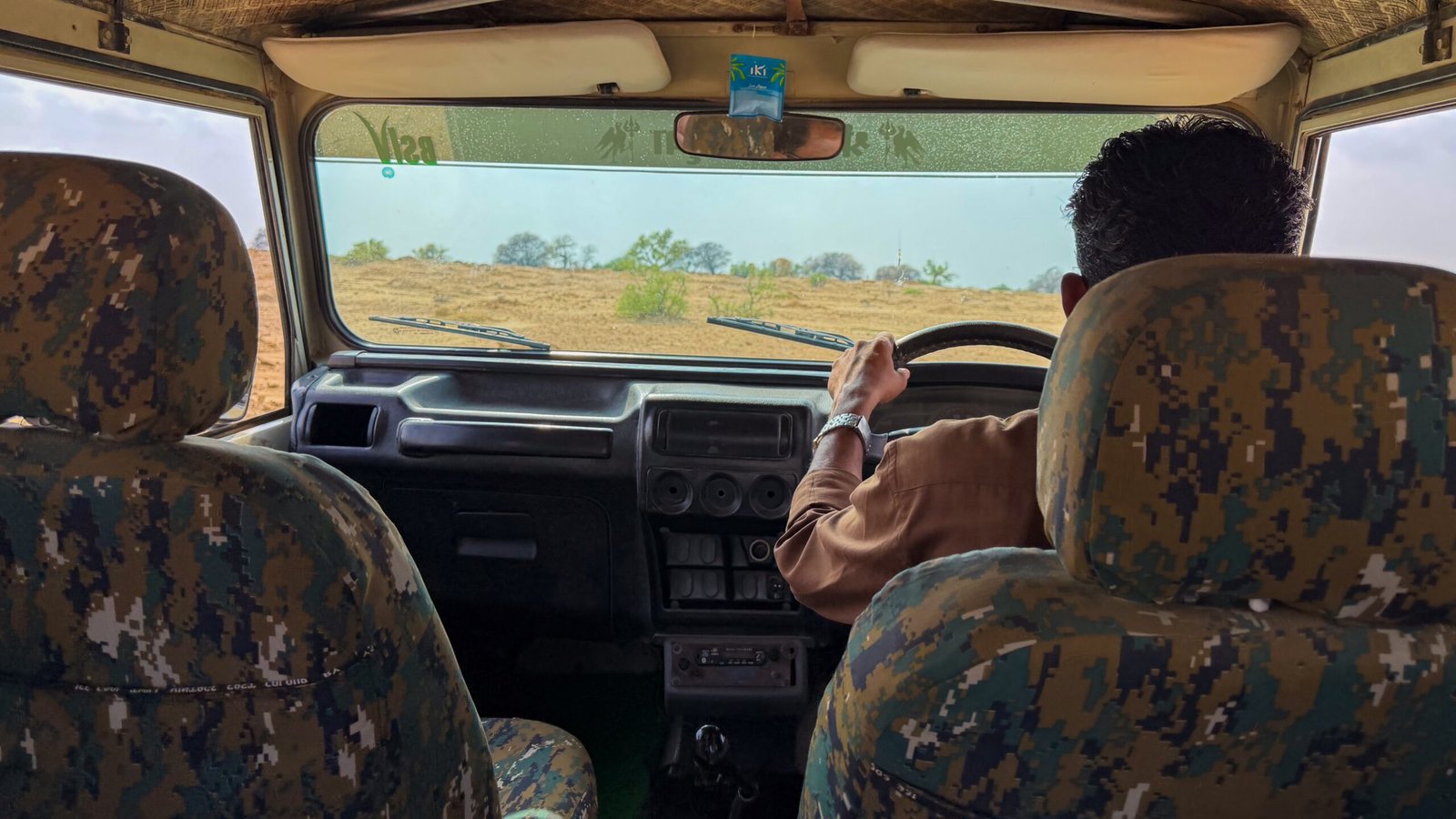 A view from the inside of a desert jeep looking out into the desert