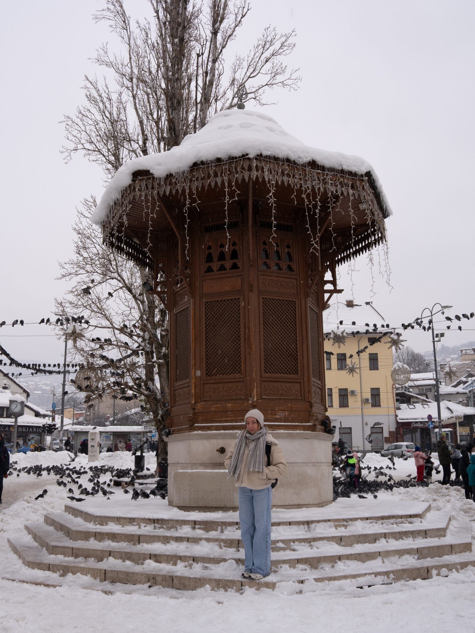 Sebilj Fountain in Sarajevo with a women stood beneath it
