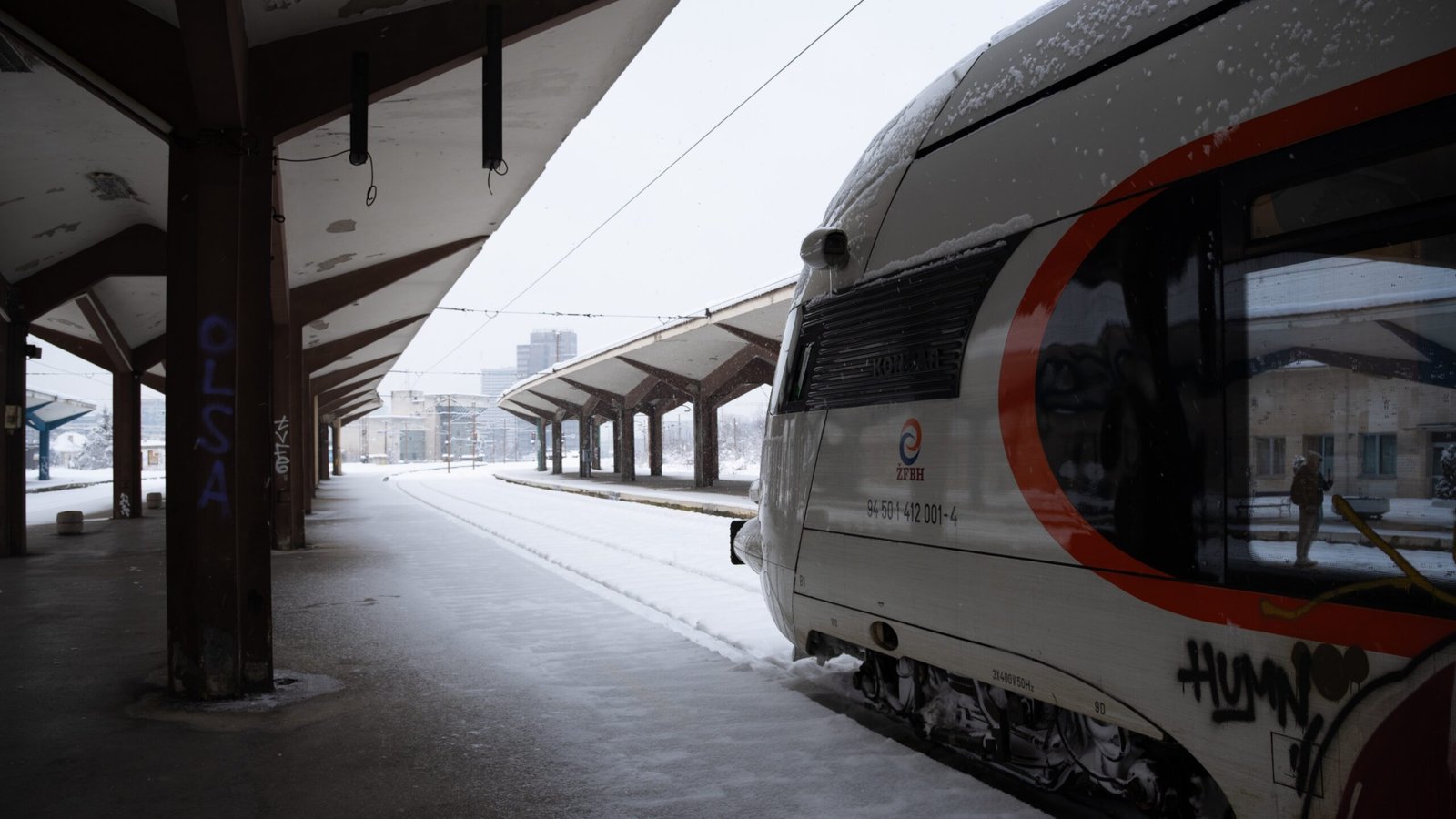 A train sat inside a train station with snow covering the area