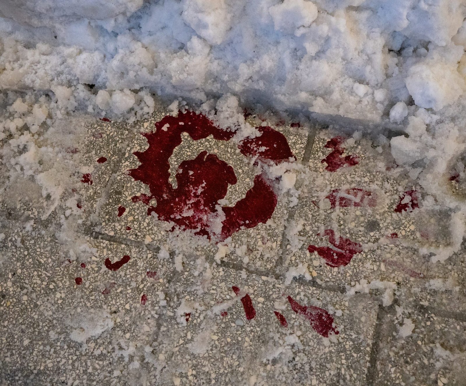 A red rose splash of paint on a snowy pathway in Sarajevo