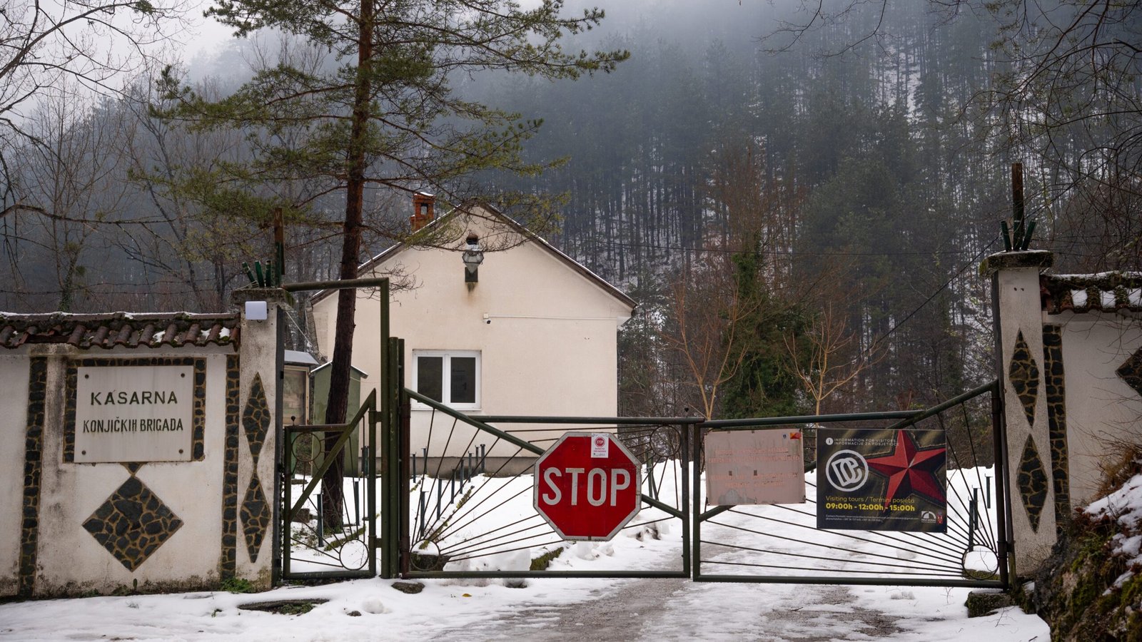 An external gate to a property showing a stop sign and Tito's Bunker