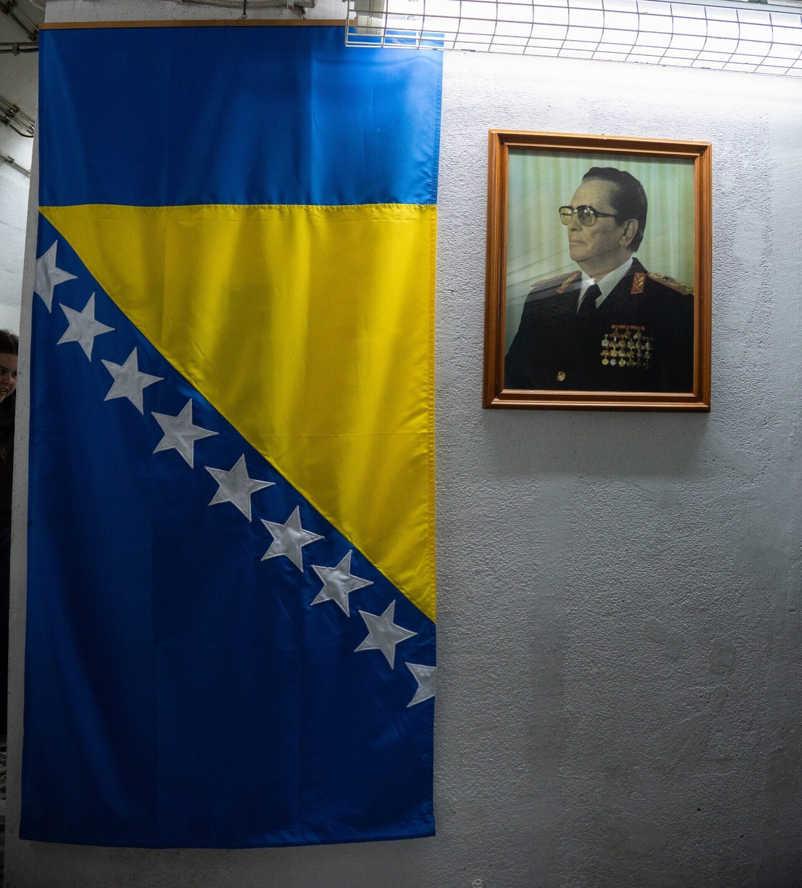 A Bosnian flag hung inside Tito's Bunker next to a framed image of Tito