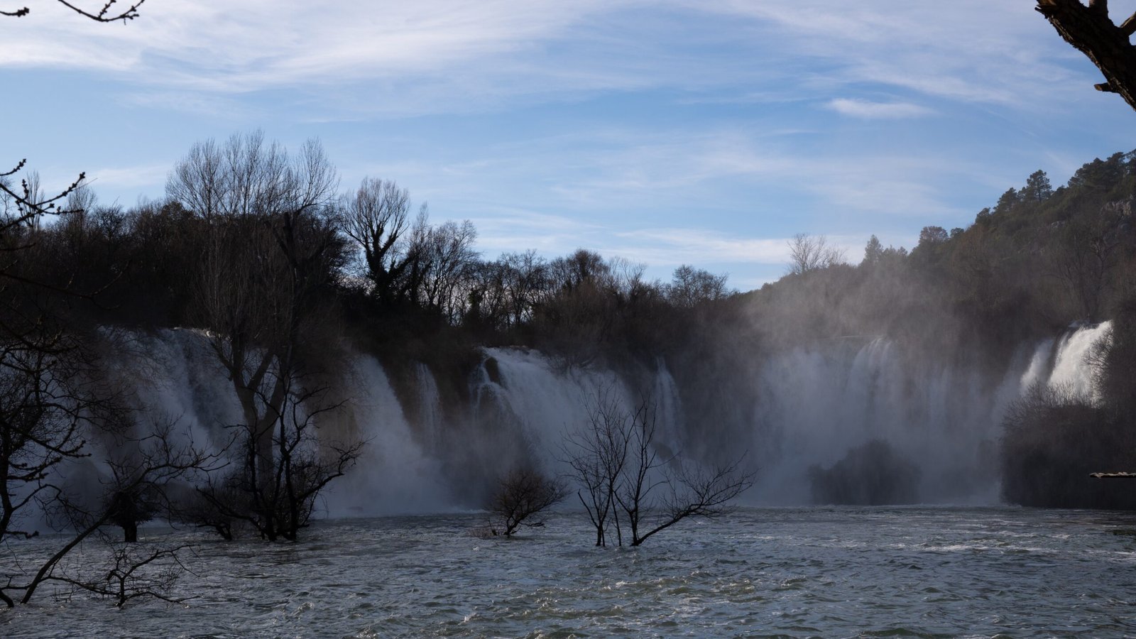 Blue skies over a wide waterfall in the cold