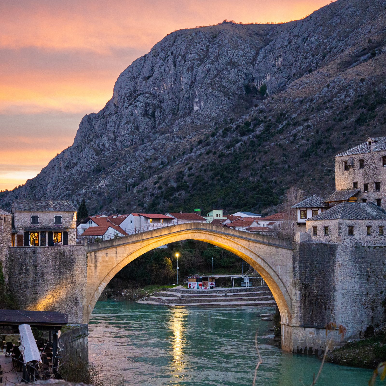 Mostar and Stari Most bridge under an orange sky, perfect for Mostar Travel Guide