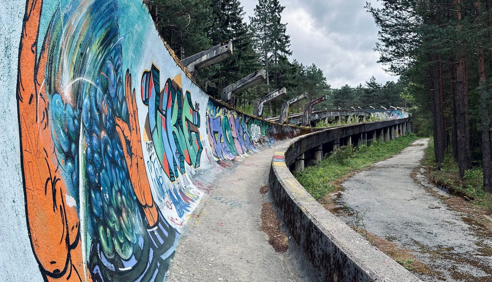 A bobsleigh track covered in graffiti